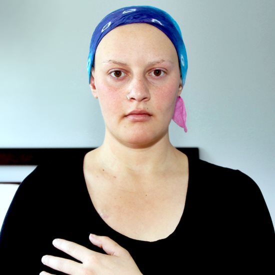 Woman with hand on breast