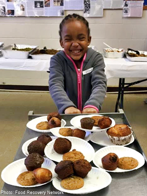 A girl receiving food at a location assisted by FRN